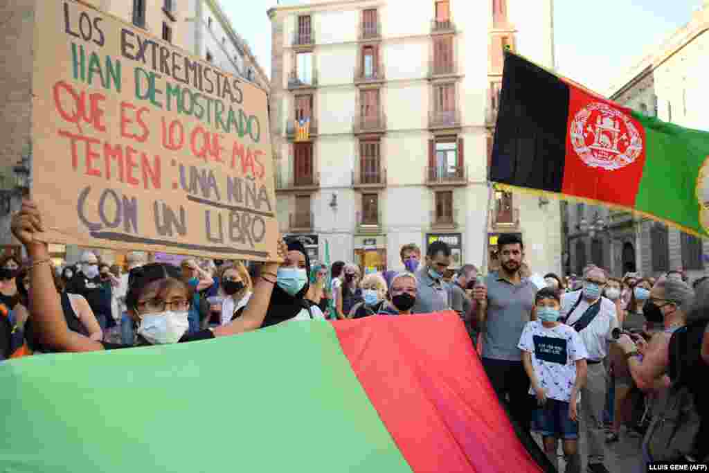 Një vajzë duke mbajtur një banderolë me porosinë &quot;Ekstremistët kanë treguar se kujt i frikësohen më së shumti: një vajze me libër&quot;, gjatë një demonstrate në Barcelonë, Spanjë, në mbështetje të grave dhe vajzave afgane. (18 gusht)