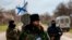 Milutin Malisic, a member of a Serbian Chetnik paramilitary group, and armed members of a local self-defence unit man a checkpoint on the highway between Simferopol and Sevastopol in the Crimean peninsular March 13, 2014
