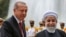 Iranian President Hassan Rohani (right) shakes hands with Turkish President Recep Tayyip Erdogan in Tehran on October 4. 