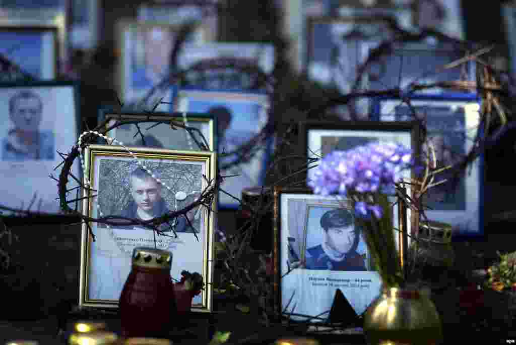Portraits of those who died during the violent protests at the Maidan Square, displayed at an improvised memorial close to a polling station in central Kyiv.