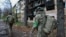 Ukrainian servicemen walk near an apartment building damaged by a Russian military strike in the frontline city of Kostyantynivka, in the Donetsk region on November 1.