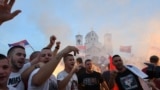 Opposition supporters celebrate victory in Montenegrin parliamentary elections in front of the Church of Christ's Resurrection in Podgorica