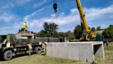 Romanian Army engineers install concrete shelters in the village of Plauru on the Danube River border between Romania and Ukraine on September 12, 2023.