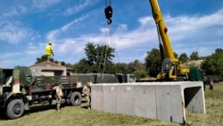 Romanian Army engineers install concrete shelters in the village of Plauru on the Danube River border between Romania and Ukraine on September 12, 2023.