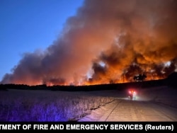 Egy bozóttűz lángjai és füstje Ginginben, Nyugat-Ausztráliában.