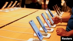 India - A person holds an Apple iPhone at the company's first retail store in Bengaluru, September 2, 2025.