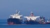 The Liberian-flagged oil tanker Ice Energy (left) transfers crude oil from the Iranian-flagged oil tanker Lana (former Pegas), off the shore of the Greek island of Evia on May 26.