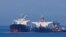 The Liberian-flagged oil tanker Ice Energy (left) transfers crude oil from the Iranian-flagged oil tanker Lana (former Pegas), off the shore of the Greek island of Evia on May 26.