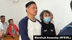 Qosai Makhanbaev (center) in court earlier this month.