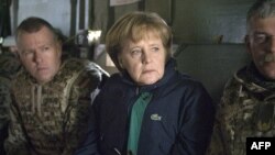 German Chancellor Angela Merkel travels in a helicopter with German troops during a surprise visit to their base in the northern Afghan city of Kunduz in April.