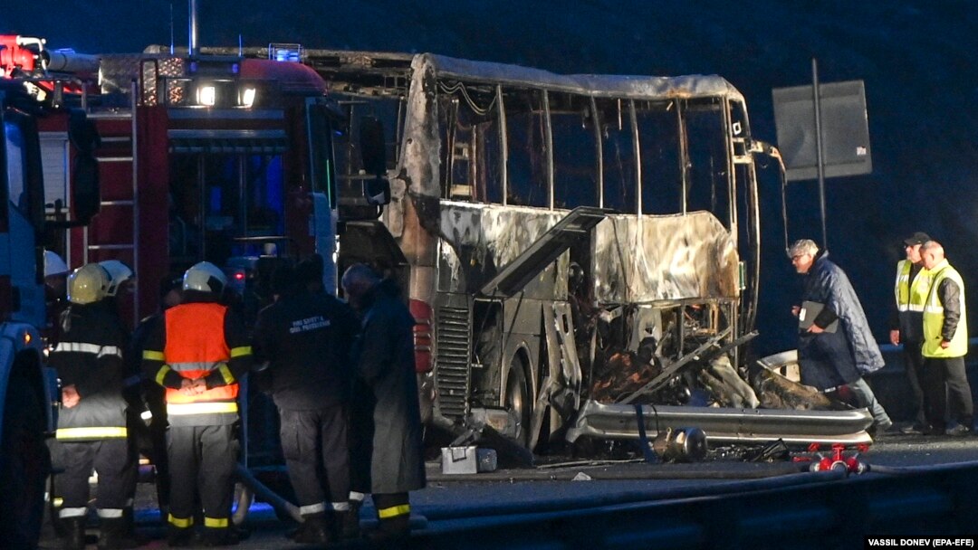 Firefighters, police, and investigators inspect the wreckage of the bus near the village of Bosnek, Bulgaria, on November 23.