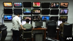 Journalists work in the newsroom at TOLOnews, the country's leading independent television network.