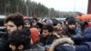 Migrants jostle as they wait to receive food in Belarus.&nbsp;Polish Prime Minister Mateusz Morawiecki on November 21 said that Belarusian leader Alyaksandr Lukashenka had launched a &quot;hybrid war&quot; against the European Union.