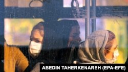 Gratë iraniane mbajnë maska, teksa udhëtojnë me një autobus në Teheran. Shkurt, 2020. 