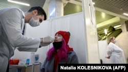 A woman takes a free rapid antigen test for COVID-19 at a testing center in Moscow. 