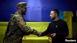 Ukrainian President Volodymyr Zelenskiy presents a soldier with a medal as he visited Ukrainian forces in Zaporizhzhya on March 27.