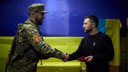 Ukrainian President Volodymyr Zelenskiy presents a soldier with a medal as he visited Ukrainian forces in Zaporizhzhya on March 27.