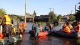RUSSIA -- Members of the Russian Emergencies Ministry evacuate people during a rescue operation in a flood-affected town of Tulun in Irkutsk Region, Russia July 1, 2019.