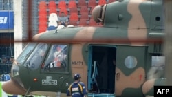 A Sri Lankan cricketer boards a Pakistani military helicopter to evacuate from Gaddafi Stadium in the wake of the deadly attack on March 3.