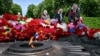 People lay flowers on the Tomb of the Unknown Soldier to mark Victory Day over Nazism in World War II, at the Eternal Glory park in Kyiv on May 9.