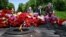 People lay flowers on the Tomb of the Unknown Soldier to mark Victory Day over Nazism in World War II, at the Eternal Glory park in Kyiv on May 9.