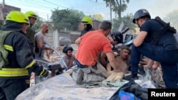 Rescue workers treat a wounded man after a Russian strike on Dnipro on June 28.