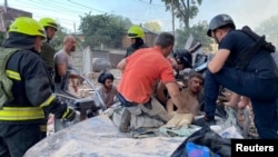 Rescue workers cope treat a wounded man after a Russian strike on Dnipro, Ukraine, on June 28.