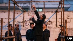 Officials prepare the noose for the execution in Iran.