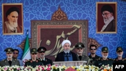 A handout picture provided by the Iranian presidency on September 22, 2019 shows President Hassan Rouhani (C) giving a speech during the annual "Sacred Defence Week" military parade marking the anniversary of the outbreak of the devastating 1980-1988 war 