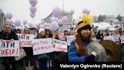 Marchers held posters protesting domestic violence, sexual violence, sexism and discrimination by gender.