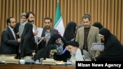 Head of Iran's Judiciary Ebrahim Raeesi speaking with an aide to President Hassan Rouhani during an event about women's issues. June 1, 2019