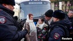 Članice ženskog pokreta "Put kući", koje traže povratak svojih muževa koji su se pridružili ruskim oružanim snagama uključenim u rat u Ukrajini, stoje okružene policajcima tokom skupa u centru Moskve, Rusija, 3. februar 2024.