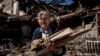 A woman collects wood for heating from a destroyed school in the Izyum area, which was recently recaptured by Ukraine. Massive Russian missile strikes targeting the country’s civilian heating infrastructure means that many Ukrainians could be in for a cold winter this year. 