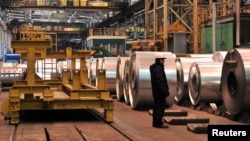 An employee stands near galvanized coils at the Novolipetsk steel mill in Lipetsk, Russia. The proposed eighth sanctions package includes, among other things, a ban on Russian steel and steel products. 