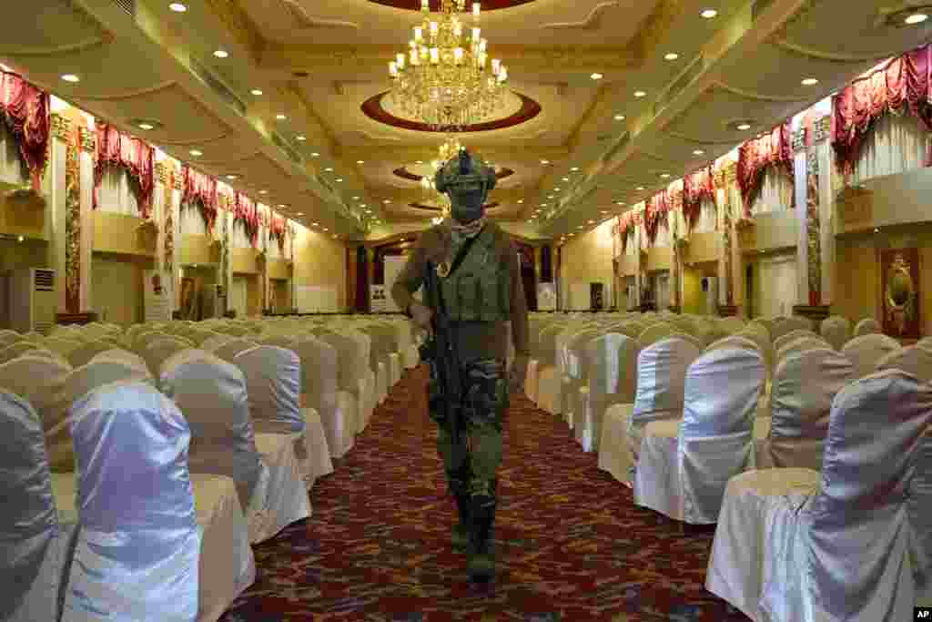 A Taliban fighter does a security inspection on September 19 of the ceremonial hall at the Intercontinental Hotel in Kabul that will host an announcement of the release from a U.S. prison of Bashir Noorzai, a notorious drug lord being swapped for kidnapped American contractor Mark Frerichs.