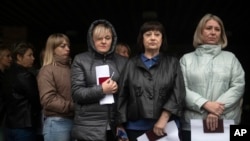 People wait to vote in front of a mobile polling station in Luhansk on September 23.