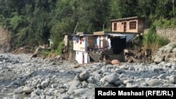 Homes damaged along the banks of the Bishigram River in Chel Deepu.