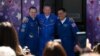 NASA astronaut Frank Rubio (right) and Russian cosmonauts Sergei Prokopyev (center) and Dmitry Petelin pose in front of a bus before prelaunch preparations in September 2022.