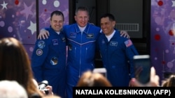 NASA astronaut Frank Rubio (right) and Russian cosmonauts Sergei Prokopyev (center) and Dmitry Petelin pose in front of a bus before prelaunch preparations in September 2022.