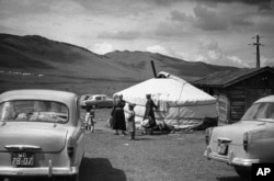 Soviet-made cars parked near yurts outside Ulan Bator in 1961.