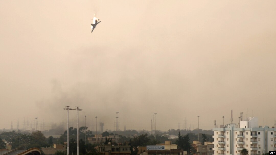 A Libyan jet bomber crashes after being shot down by rebel forces in Benghazi, as the rebel stronghold came under attack on March 19.