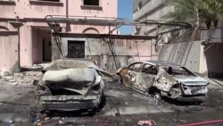 Footage from Bahrain TV on June 11 shows damage to buildings and vehicles in reportedly by debris from an intercepted Iranian projectile.