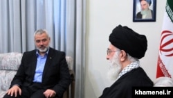 Iranian supreme leader Ayatollah Ali Khamenei meeting with Ismail Haniya (L), Palestinian Hamas leader in the Gaza Strip, during a meeting in Tehran on February 12, 2012.