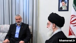 FILE PHOTO - Iranian supreme leader Ayatollah Ali Khamenei meeting with Ismail Haniya (L), Palestinian Hamas leader in Tehran on February 12, 2012.