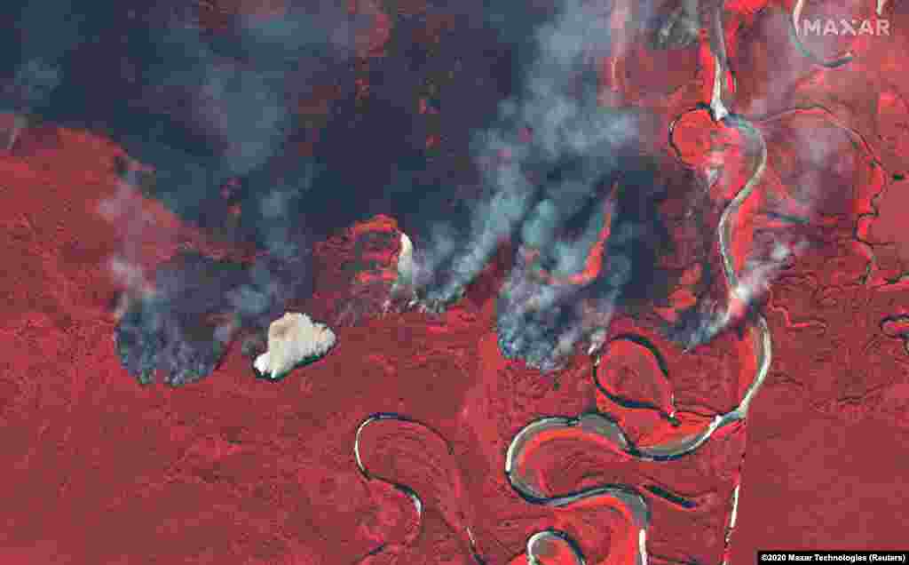 Smoke rises from wildfires near the Berezovka River in southern Russia in this color infrared image supplied by Maxar Technologies. (Maxar Technologies via Reuters)