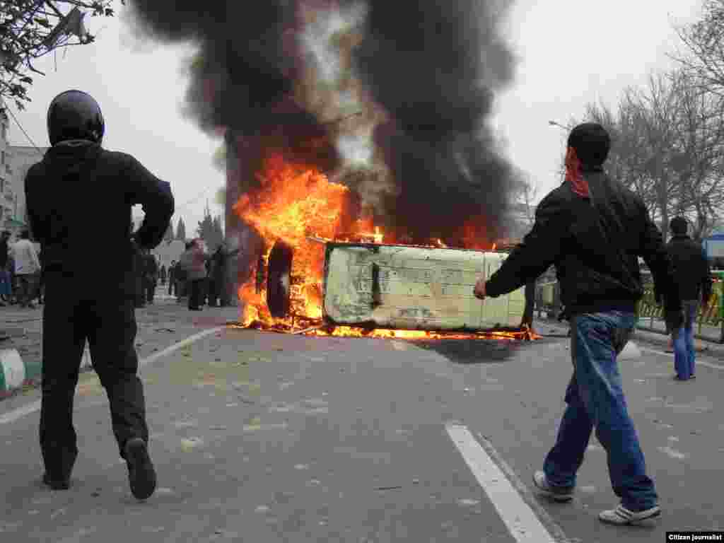 Iran -- Iranian protestors set fire on a police car during demonstrations against President Mahmud Ahmadinejad in Tehran, 27Dec2009