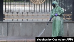 A worker disinfects a street in front of the parliament in Bishkek as Kyrgyzstan battles the coronavirus.