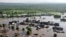An aerial image of a village on June 26 shows a flash flood caused by heavy rains in the Irkutsk region.