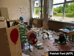 Damage and debris in a classroom of a school in the village of Kutuzyvka in Ukraine's Kharkiv region after a Russian attack in May.