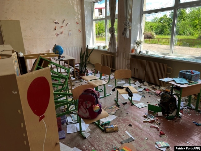 Damage and debris in a classroom of a school in the village of Kutuzyvka in Ukraine's Kharkiv region after a Russian attack in May.